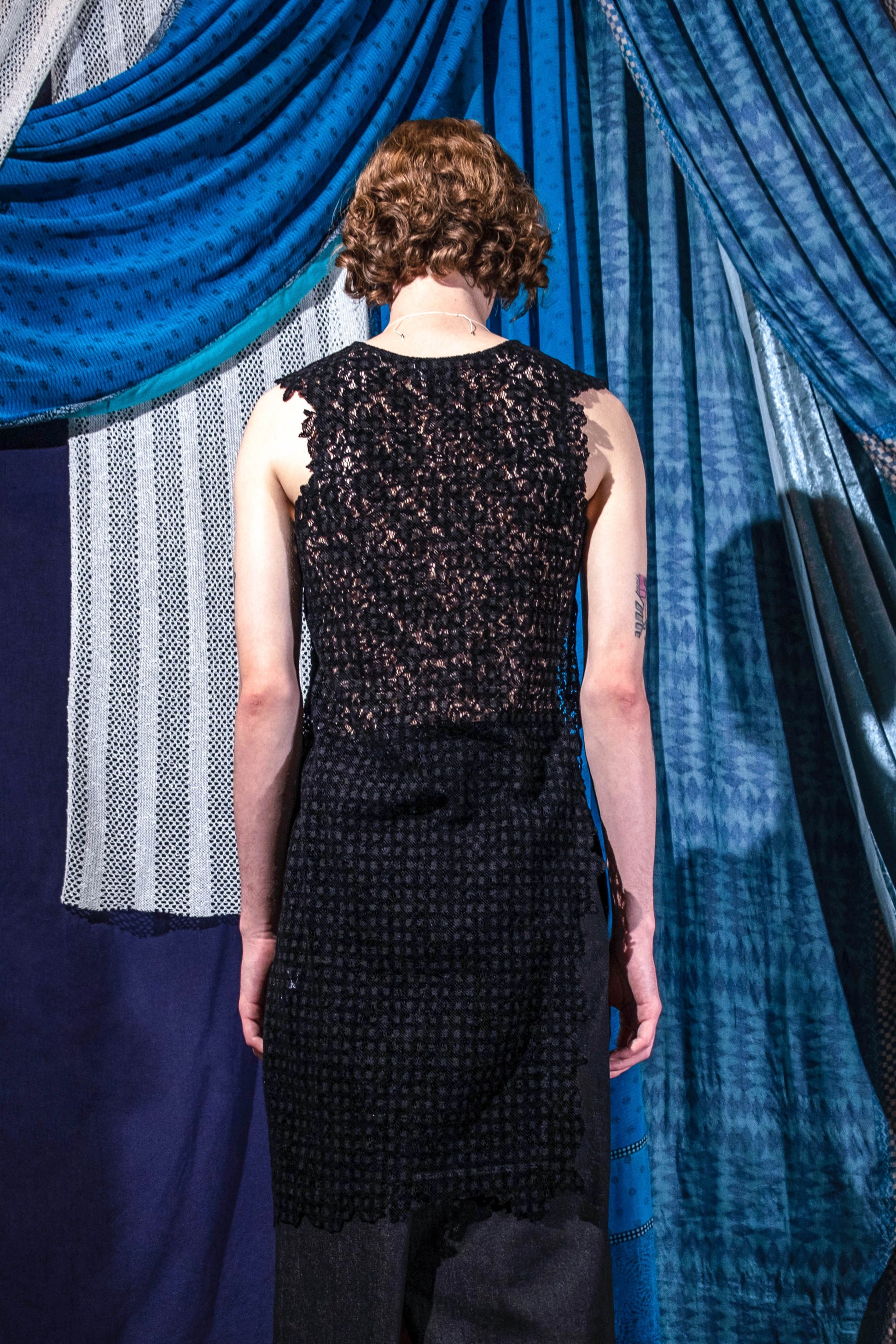 Back view of black asymmetric devoré velvet lace top